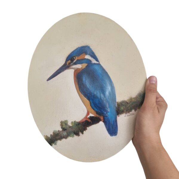 Bright blue kingfisher painting in a hand