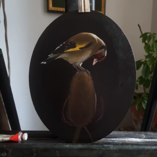 Goldfinch on a teasel painting on an easel